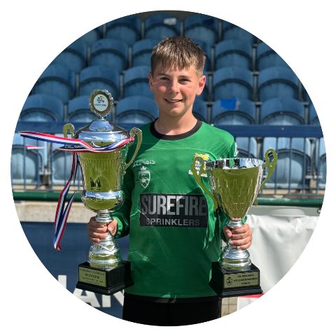 Jack holding the Easter Open winners cup and the JPL Midlands U13 league trophy